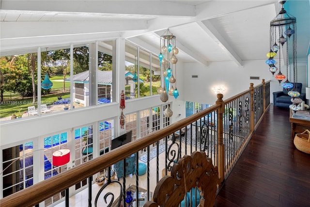 hall featuring visible vents, vaulted ceiling with beams, and hardwood / wood-style flooring