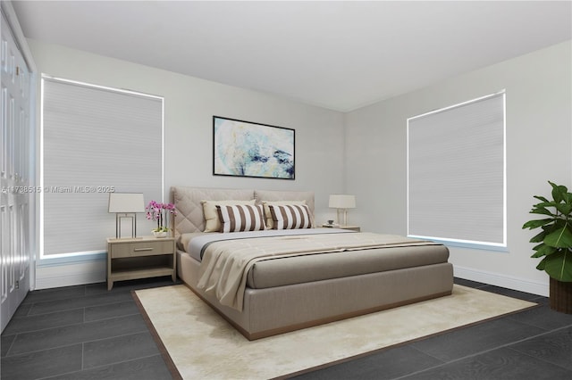 bedroom with dark tile patterned flooring and baseboards