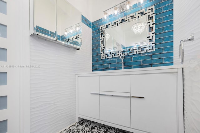 bathroom with tile patterned floors, tile walls, and an inviting chandelier