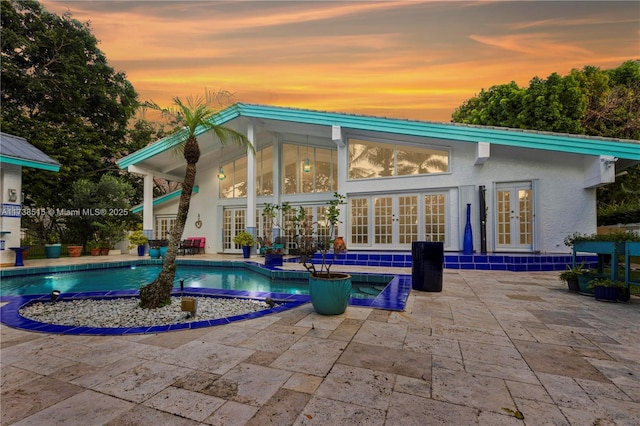 pool with a patio and french doors
