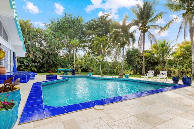outdoor pool featuring a patio