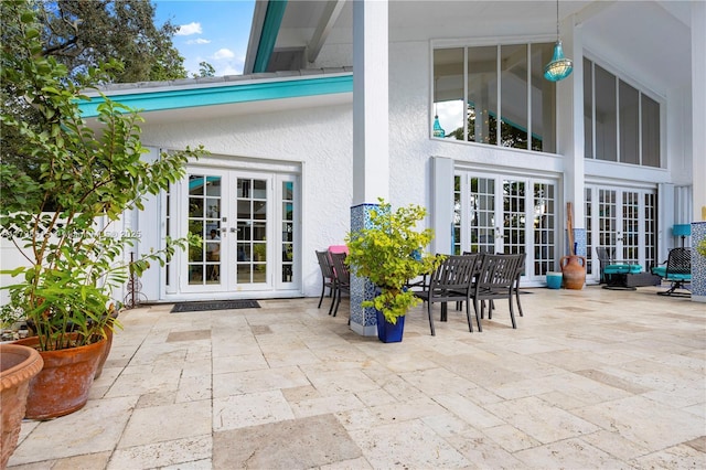 exterior space featuring french doors, a patio area, and stucco siding
