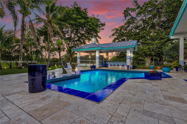 view of swimming pool featuring a fenced in pool, a patio area, fence, and a gazebo