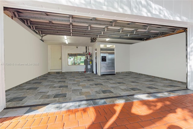 garage featuring stainless steel refrigerator with ice dispenser, a garage door opener, and water heater