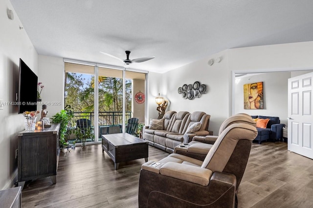 living room with ceiling fan, a wall of windows, and dark hardwood / wood-style floors