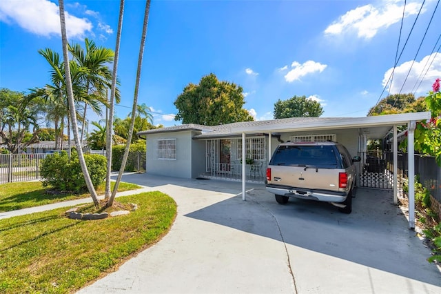 view of front facade with a front lawn and a carport