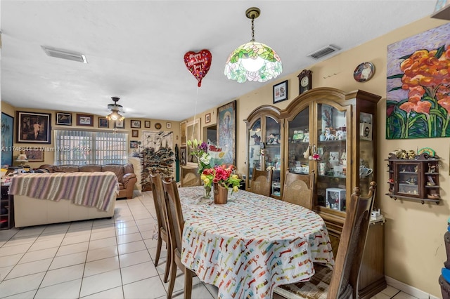 dining space with ceiling fan and light tile patterned floors