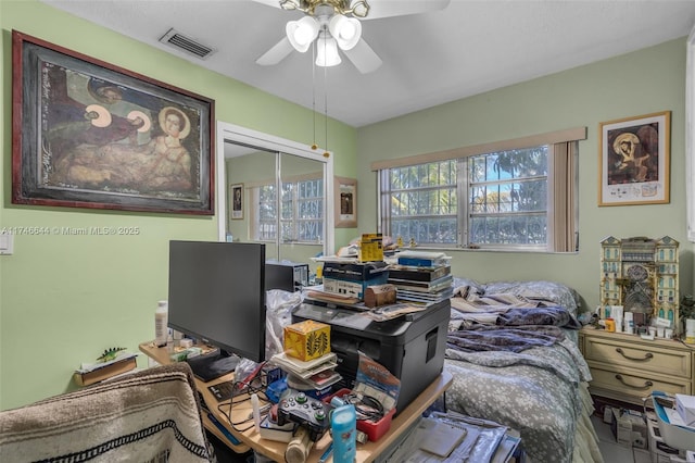 bedroom with ceiling fan and a closet