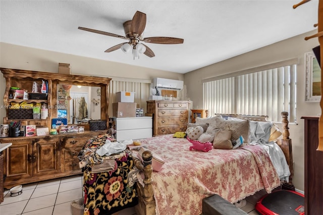 bedroom featuring a wall mounted AC, light tile patterned floors, and ceiling fan