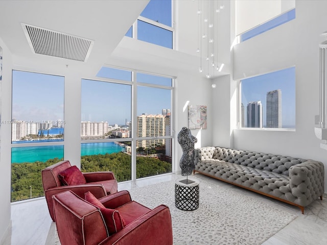 living room featuring a towering ceiling and a wealth of natural light