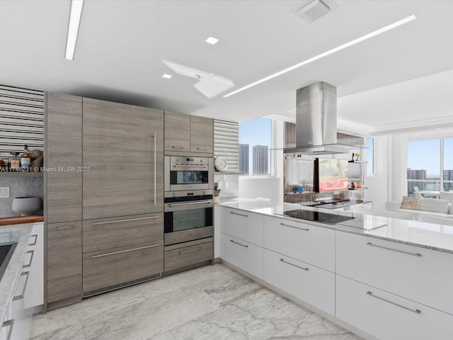 kitchen with white cabinetry, black electric cooktop, island range hood, and double oven