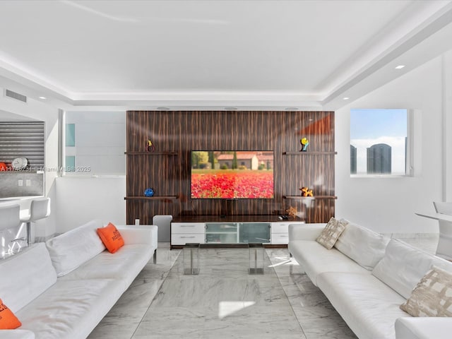 living room featuring a tray ceiling