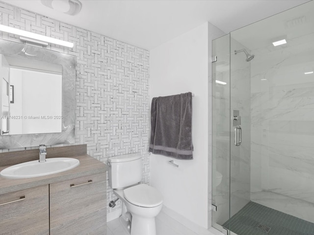 bathroom featuring tile walls, decorative backsplash, vanity, an enclosed shower, and toilet