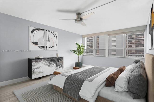 bedroom with ceiling fan and light hardwood / wood-style floors