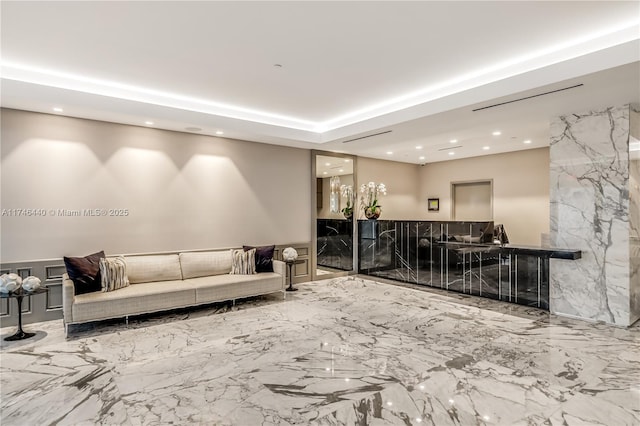 living room with a fireplace and a tray ceiling