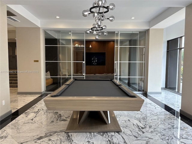 rec room with pool table and an inviting chandelier