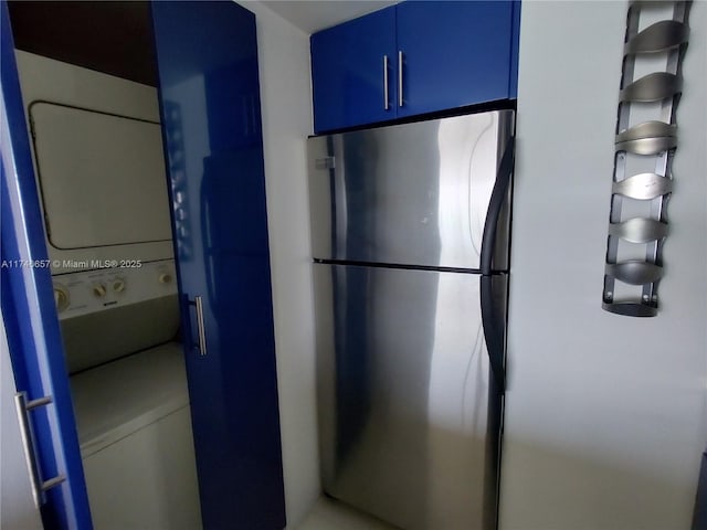 kitchen featuring stainless steel fridge and blue cabinets