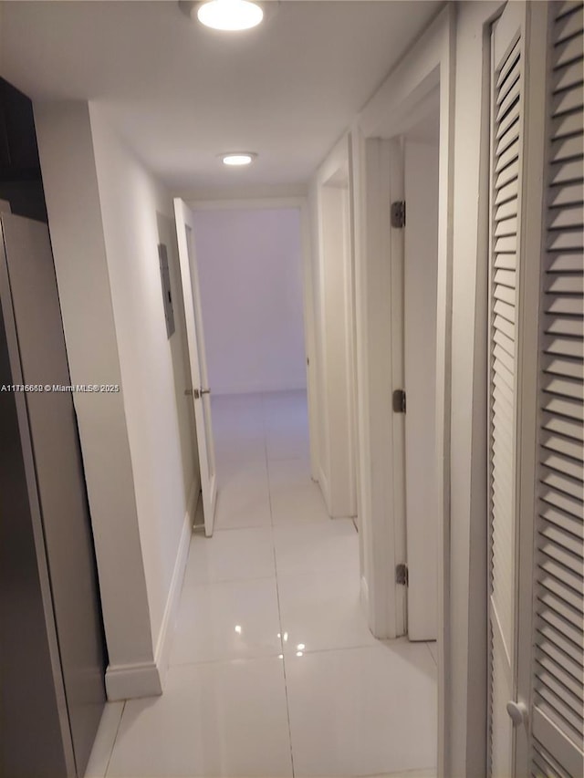 hallway featuring light tile patterned flooring