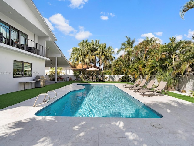 view of swimming pool with a patio and grilling area