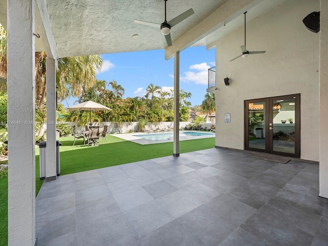 view of patio with french doors, a fenced in pool, a balcony, and ceiling fan