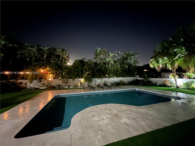 pool at night with a patio