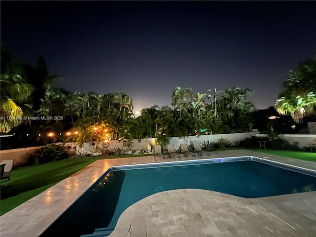 view of pool at night