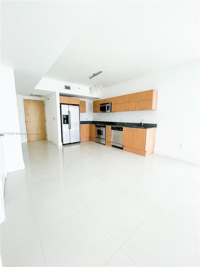 kitchen with stainless steel appliances, light tile patterned flooring, sink, and pendant lighting