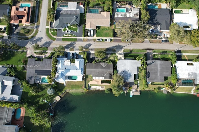 birds eye view of property featuring a water view and a residential view