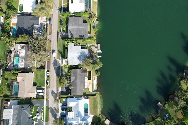 drone / aerial view with a water view and a residential view