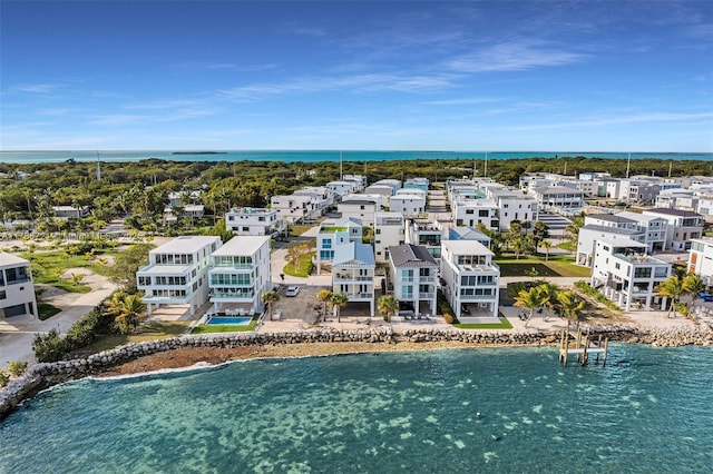 aerial view with a water view and a beach view