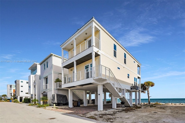 view of building exterior featuring a water view and a view of the beach