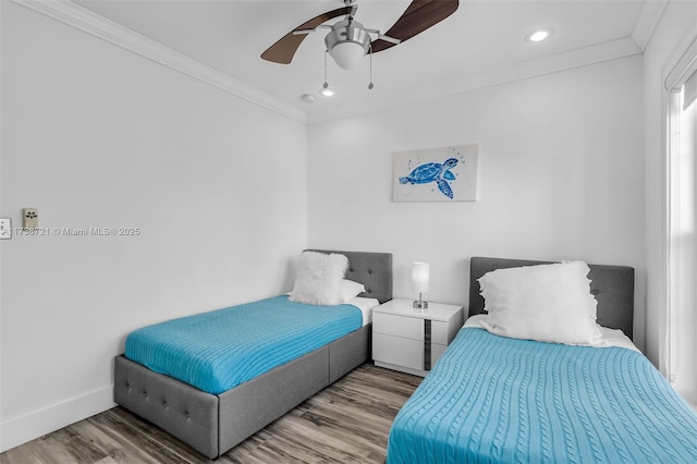 bedroom with crown molding, hardwood / wood-style floors, and ceiling fan