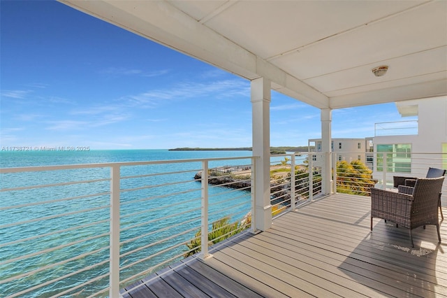 wooden deck featuring a water view