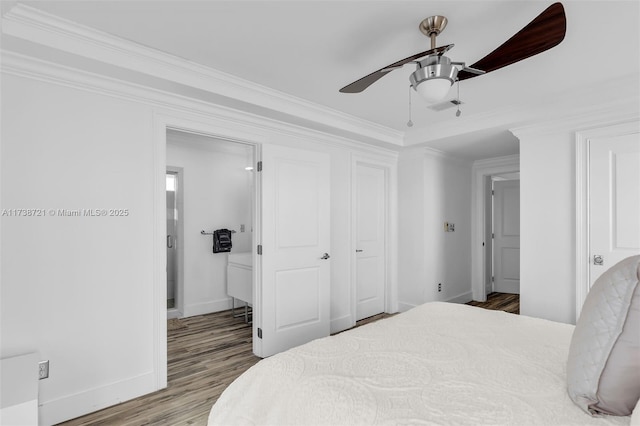 bedroom featuring ornamental molding, wood-type flooring, and ceiling fan