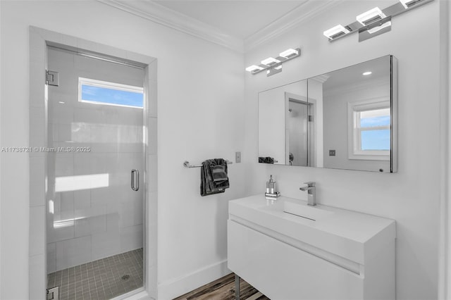 bathroom featuring ornamental molding, plenty of natural light, vanity, and walk in shower