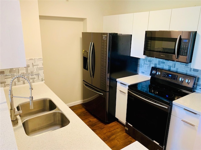 kitchen featuring electric range oven, sink, white cabinets, dark hardwood / wood-style flooring, and decorative backsplash