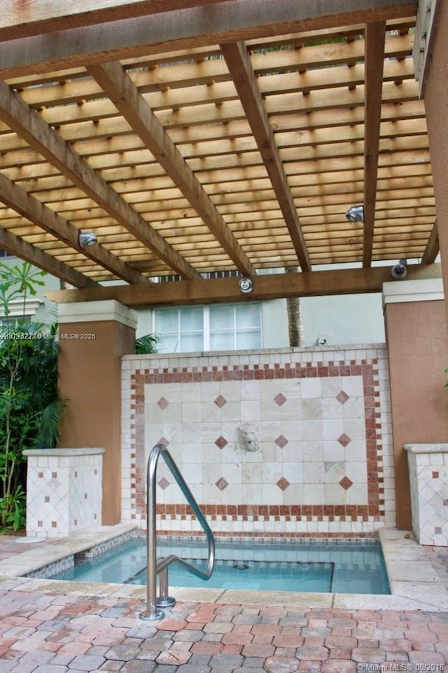 view of swimming pool with a hot tub