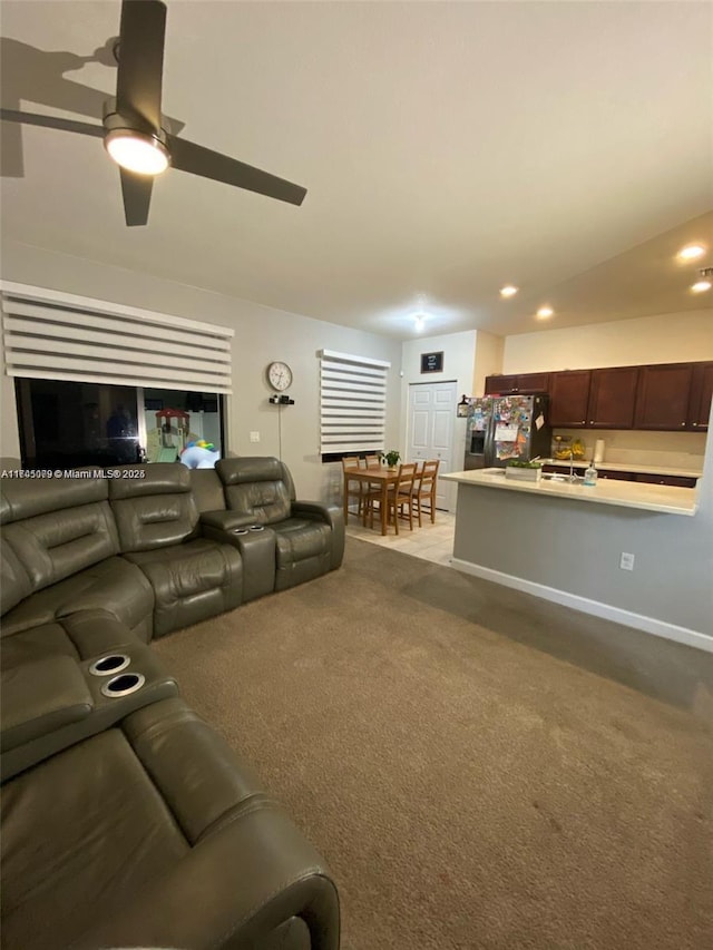 living room with ceiling fan and light colored carpet