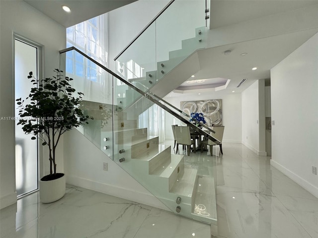 staircase with a towering ceiling