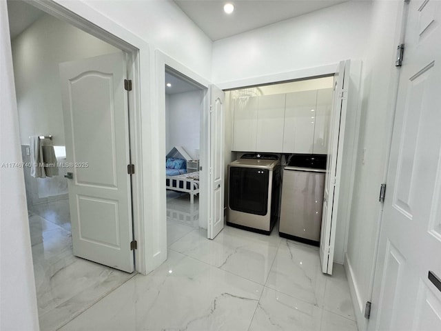 washroom with washing machine and clothes dryer