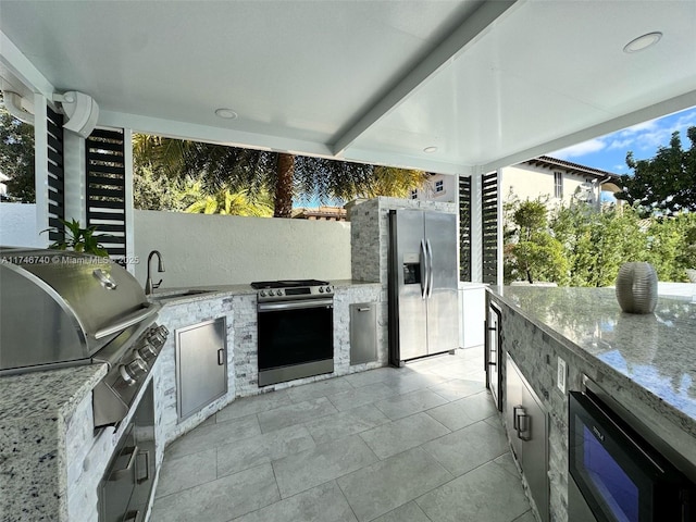 view of patio / terrace with an outdoor kitchen, area for grilling, and sink