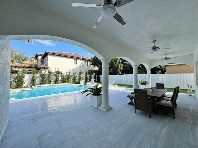 view of patio with ceiling fan and a fenced in pool