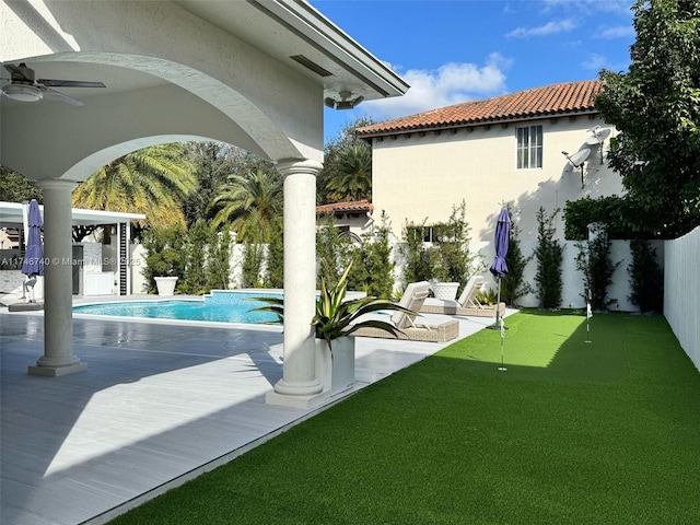 view of swimming pool featuring ceiling fan