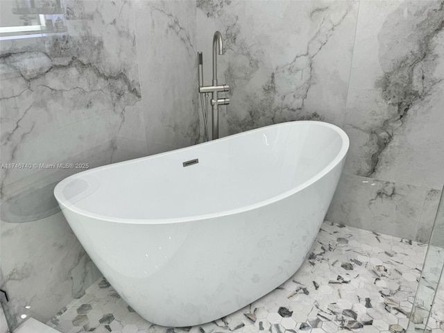 bathroom with tile walls and a bathtub