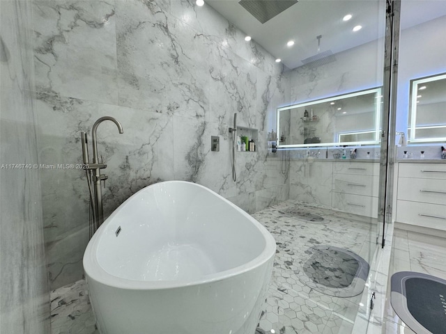 bathroom with vanity, separate shower and tub, and tile walls