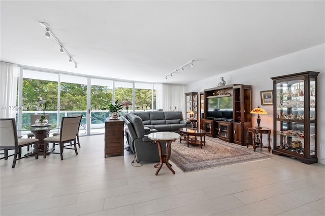 living room with track lighting and floor to ceiling windows