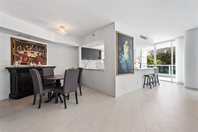 dining area with expansive windows and sink