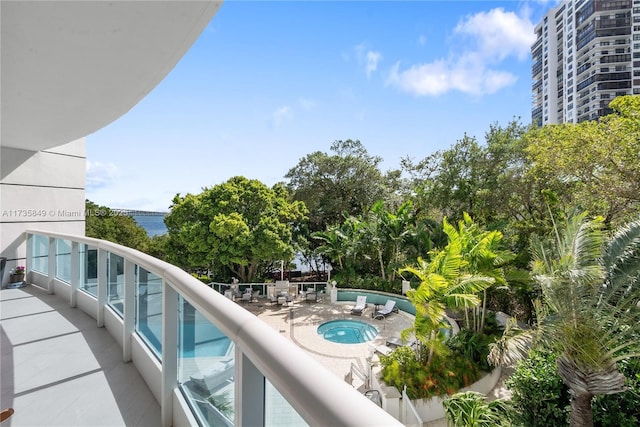 balcony featuring a community hot tub and a water view