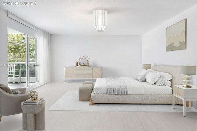 bedroom featuring an inviting chandelier and access to exterior