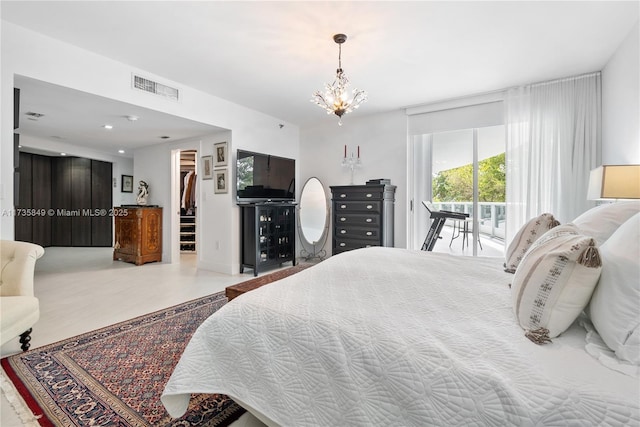 bedroom featuring an inviting chandelier, a spacious closet, and access to outside